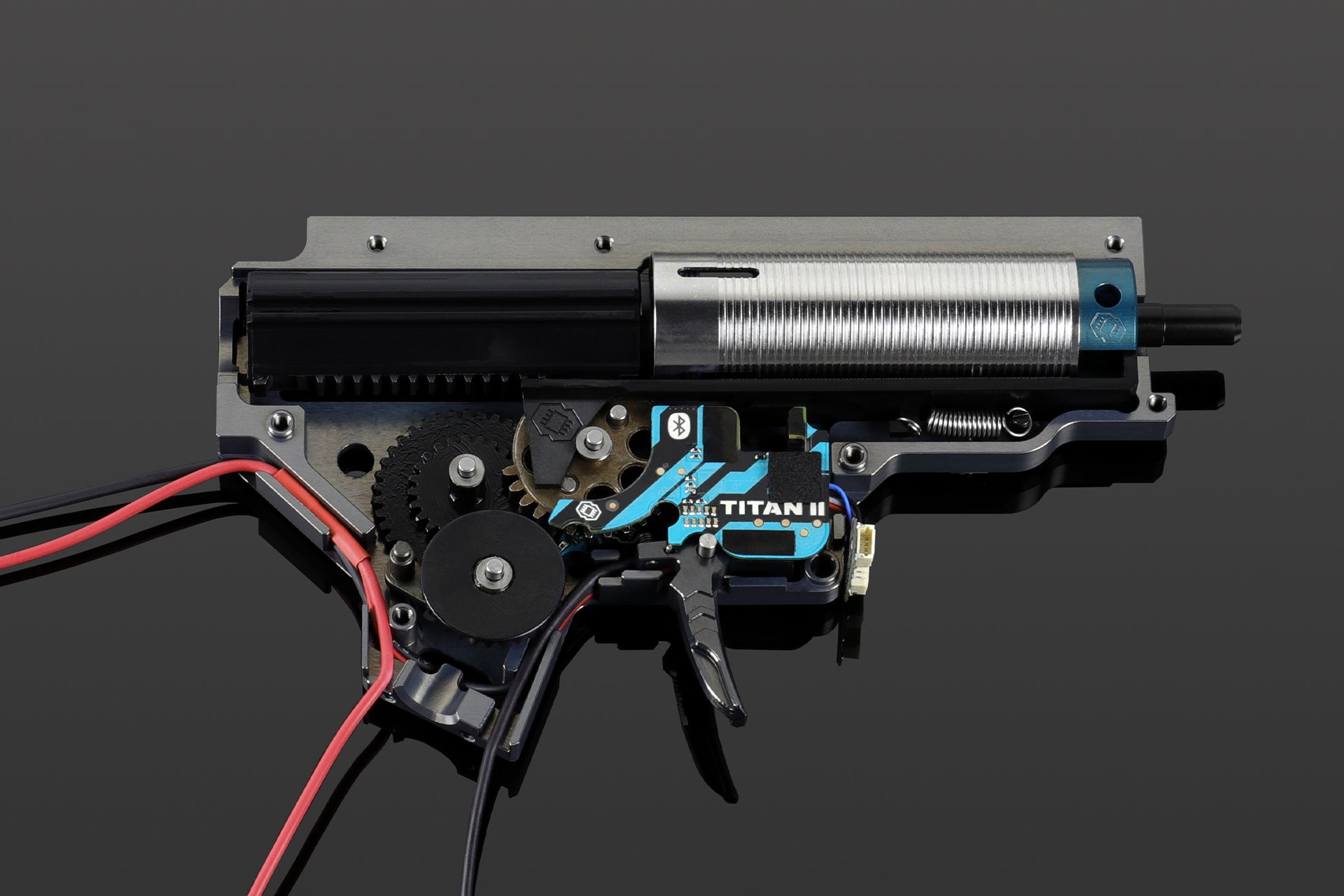 Airsoft AEG V2 gearbox opened showing internal gears, cylinder, piston and a GATE TITAN II ETU installed